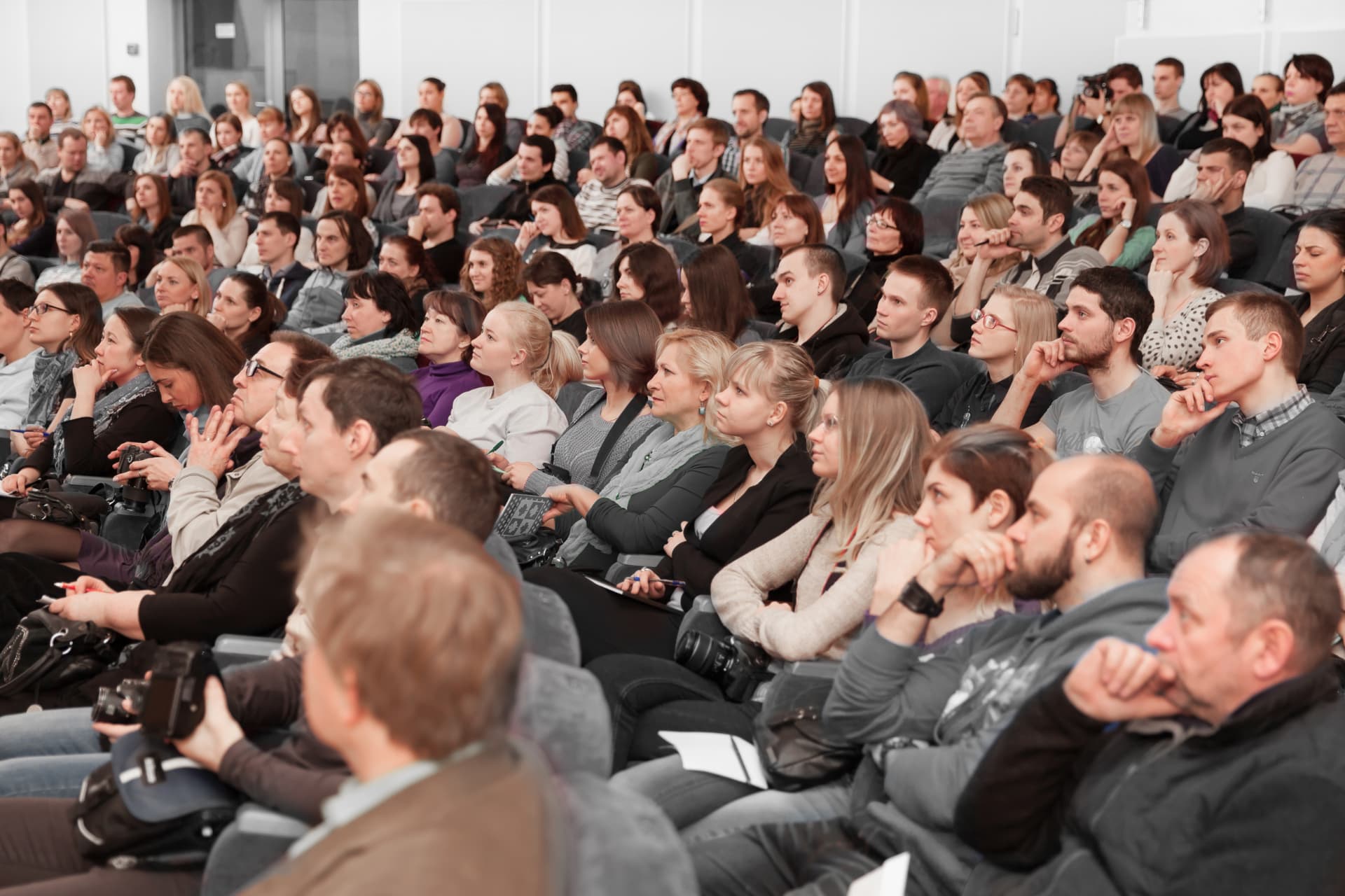 Audience seated in a modern conference hall during a keynote session
